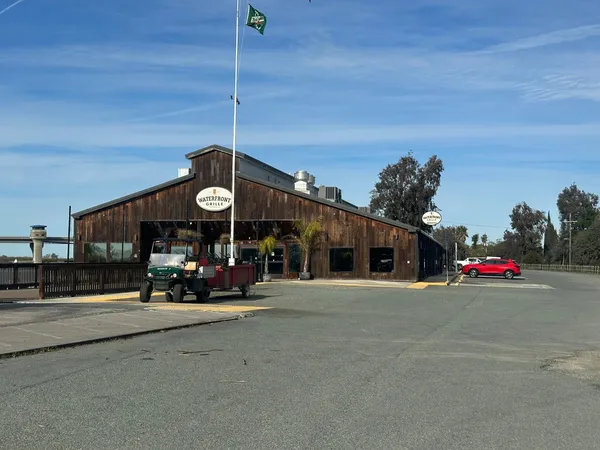 a roof deck with a table and chairs with wooden floor