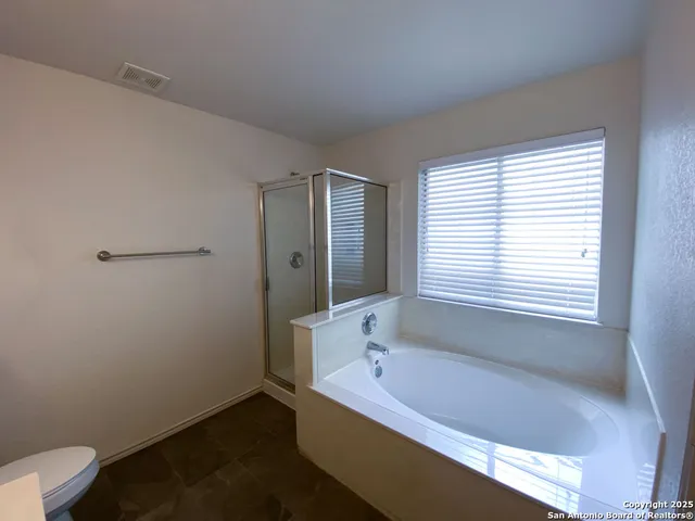 a bathroom with a bathtub and window