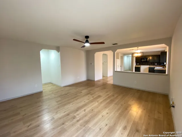 a view of a room with wooden floor and white walls