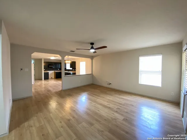 wooden floor in an empty room with a window