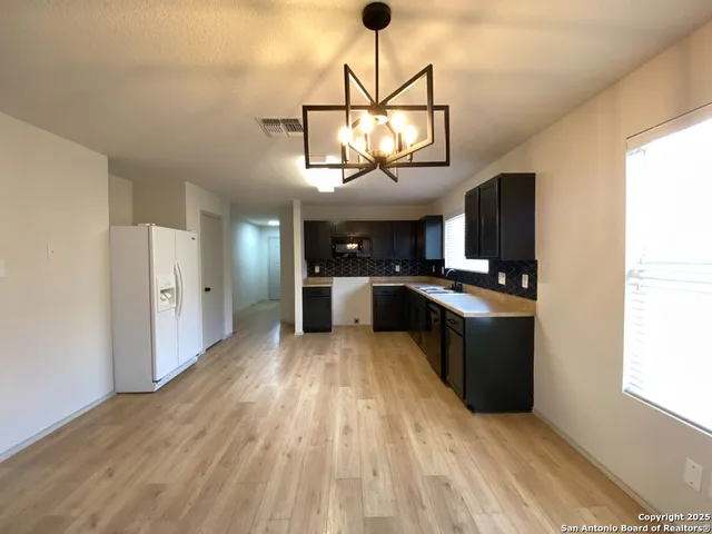 a view of a kitchen with a sink stainless steel appliances and cabinets
