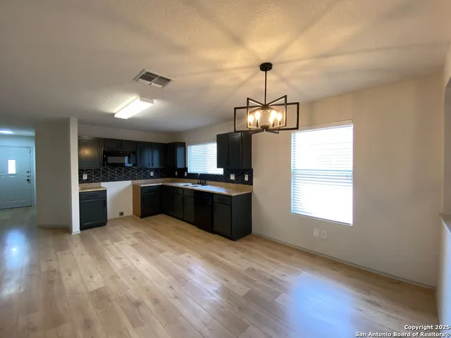 a kitchen with stainless steel appliances granite countertop a sink a stove and a refrigerator