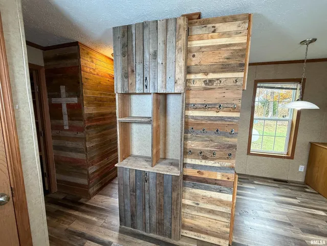 a view of a hallway with wooden floor and door