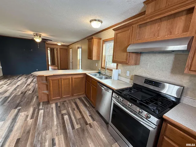 a kitchen with a stove a sink and a cabinets