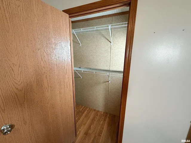 a view of hallway with wooden floor