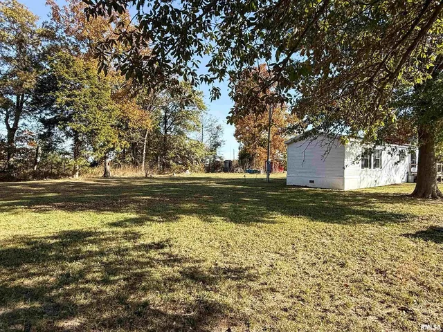 a view of big yard with a yard