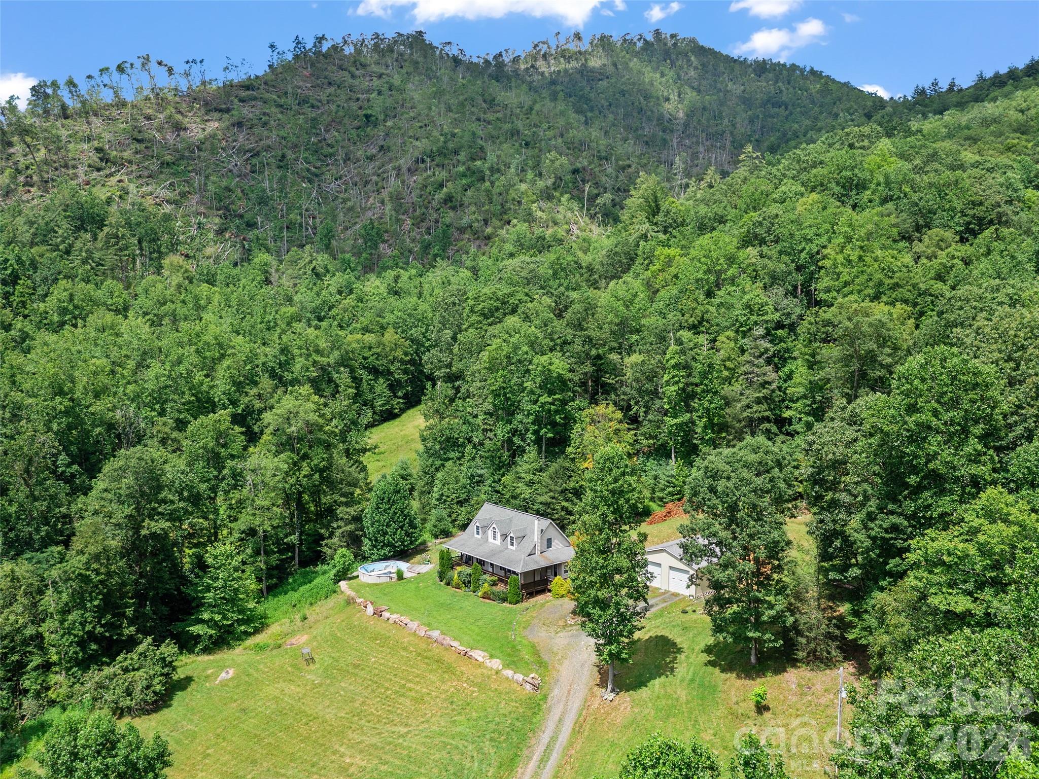 2216 Beans Creek Road Bakersville, NC 28705 - Photo 1 of 39 a backyard of a house with a yard and outdoor seating