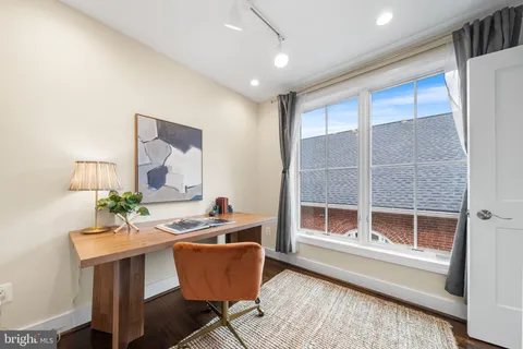 a workspace with furniture window and wooden floor