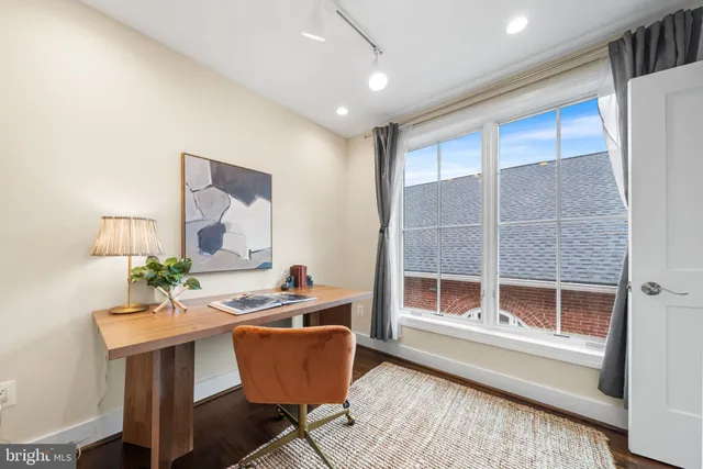 a workspace with furniture window and wooden floor