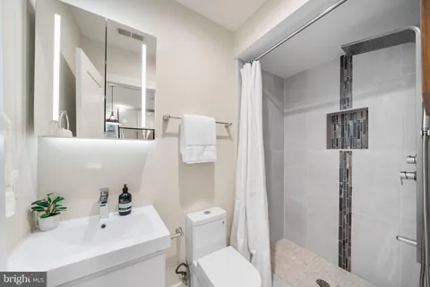 a bathroom with a sink toilet and shower