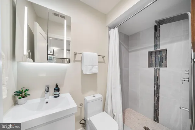 a bathroom with a sink toilet and shower