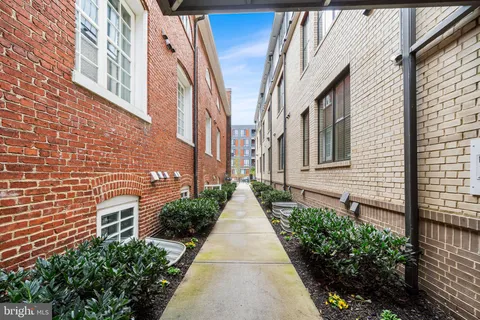 a view of a pathway along with brick walls