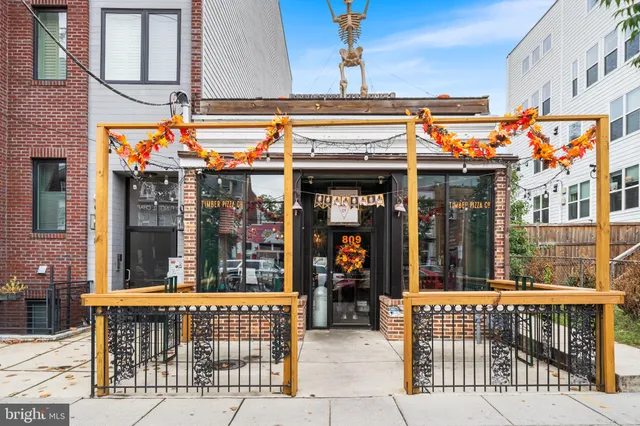 a view of a cafe with sitting area and furniture
