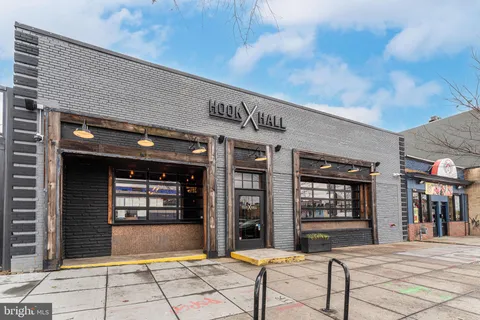 a front view of a building with outdoor seating