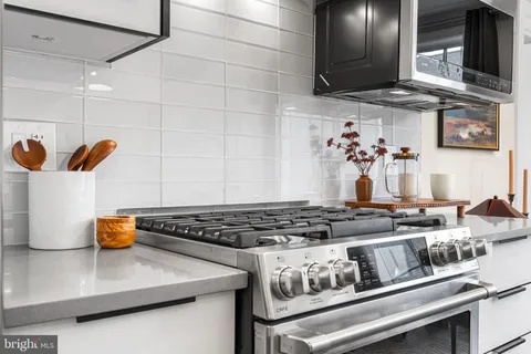 a kitchen with a stove and cabinets