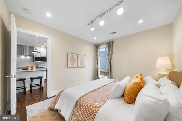 a bedroom with a bed and a chandelier