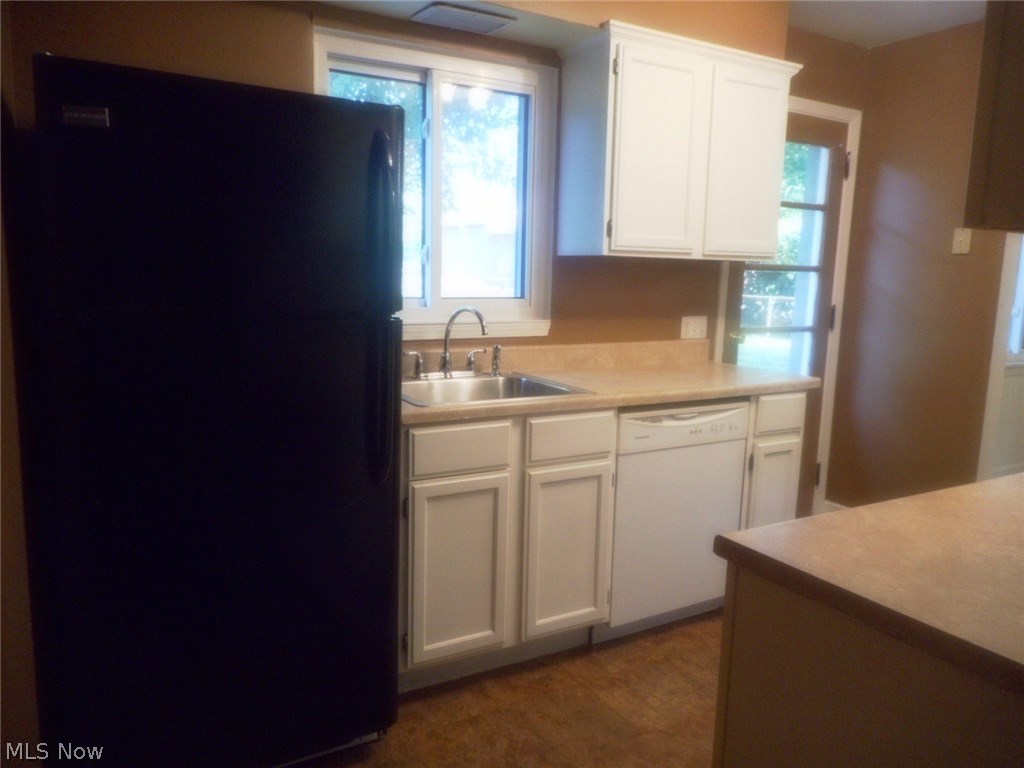 908 Jacoby Road Akron, OH 44321 - Photo 6 of 24 The kitchen overlooks the patio and the backyard. It has newer neutral countertops.