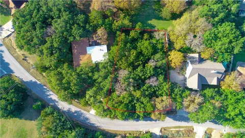 an aerial view of a house with garden space and street view