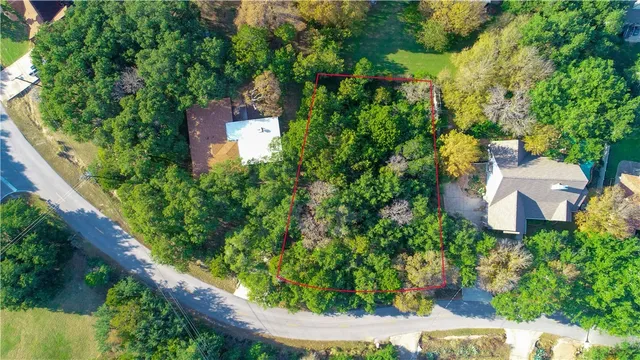 an aerial view of a house with garden space and street view