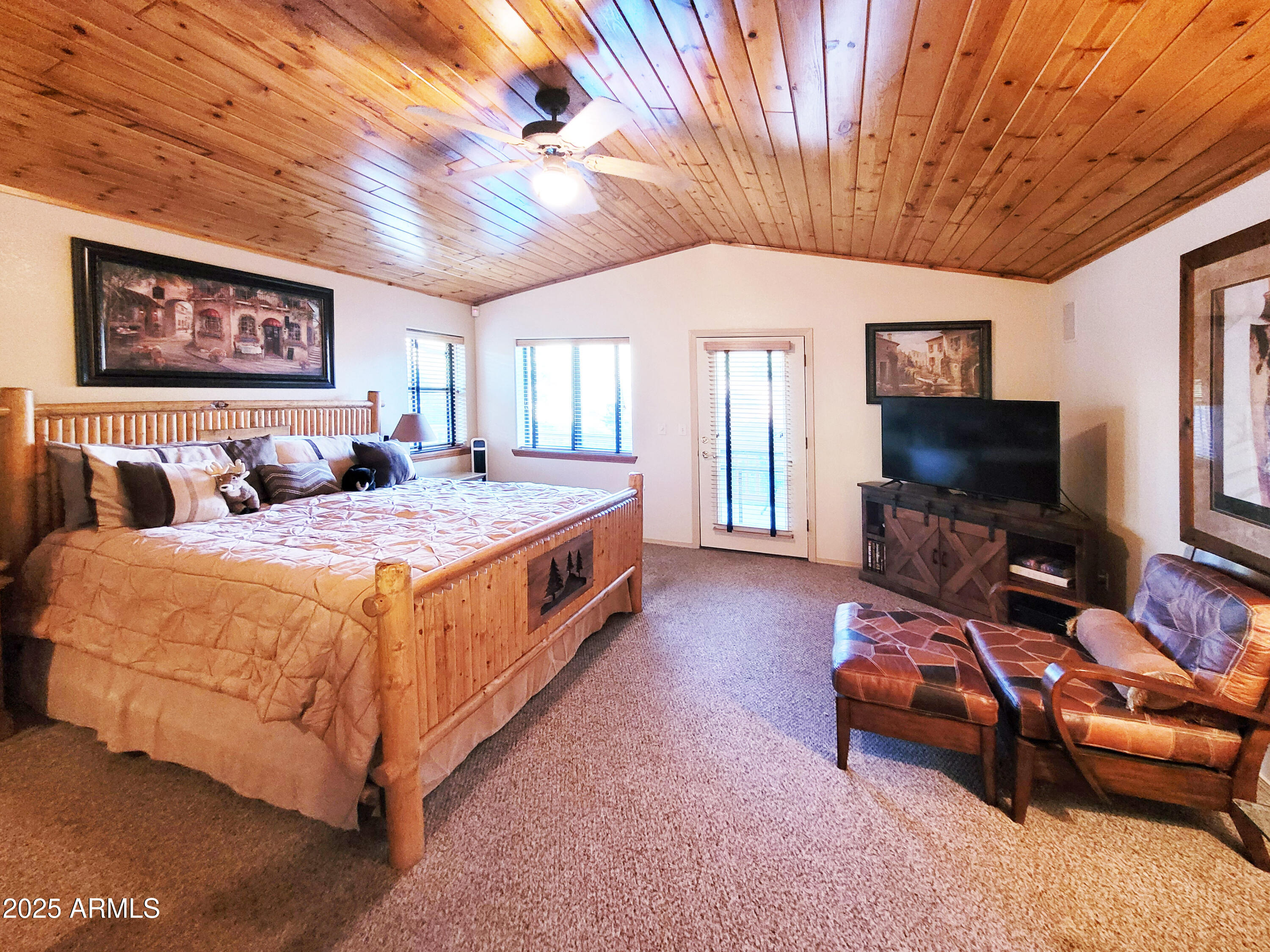 5579 Solitude Trail Loop Pine, AZ 85544 - Photo 28 of 50 a spacious bedroom with a bed and a flat screen tv