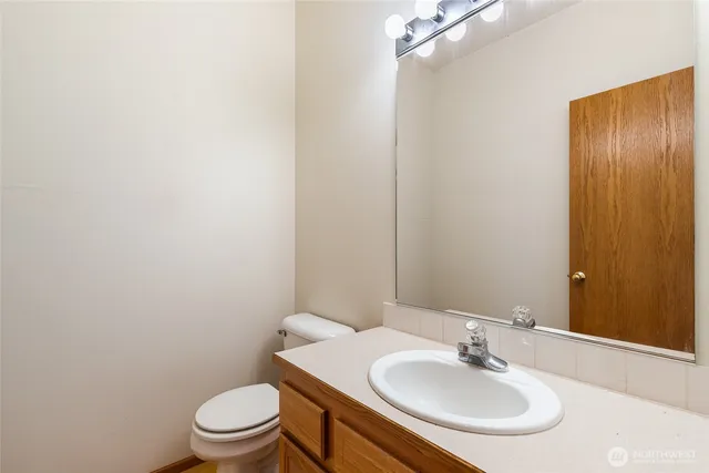 a bathroom with a sink toilet and a mirror
