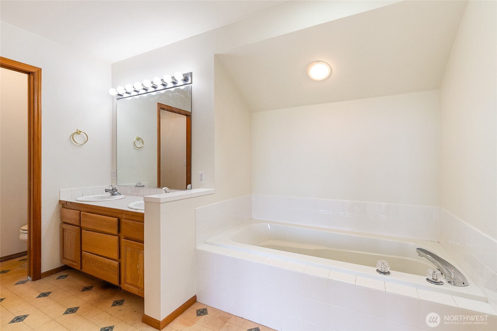 114 Twin Sisters Loop Lynden, WA 98264 - Photo 23 of 24 a bathroom with a tub sink and mirror