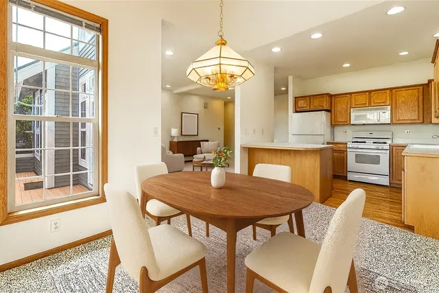 a view of a dining room with furniture window and wooden floor