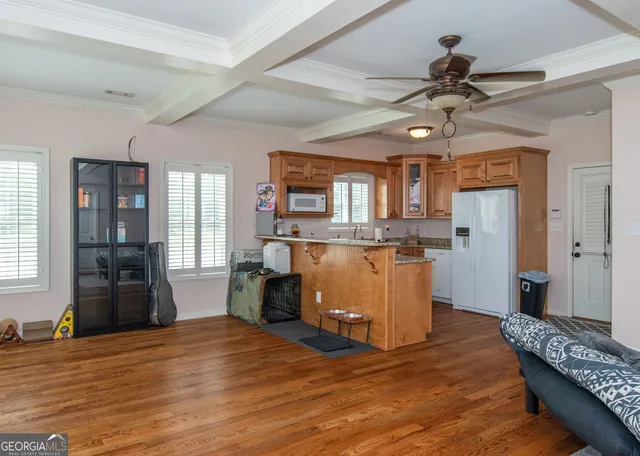 a kitchen with stainless steel appliances kitchen island granite countertop a refrigerator a stove top oven a sink and dishwasher