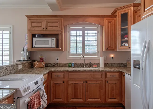 a bathroom with a granite countertop double vanity sink and a mirror