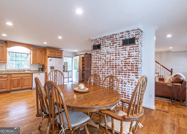 a view of a dining room with furniture and wooden floor