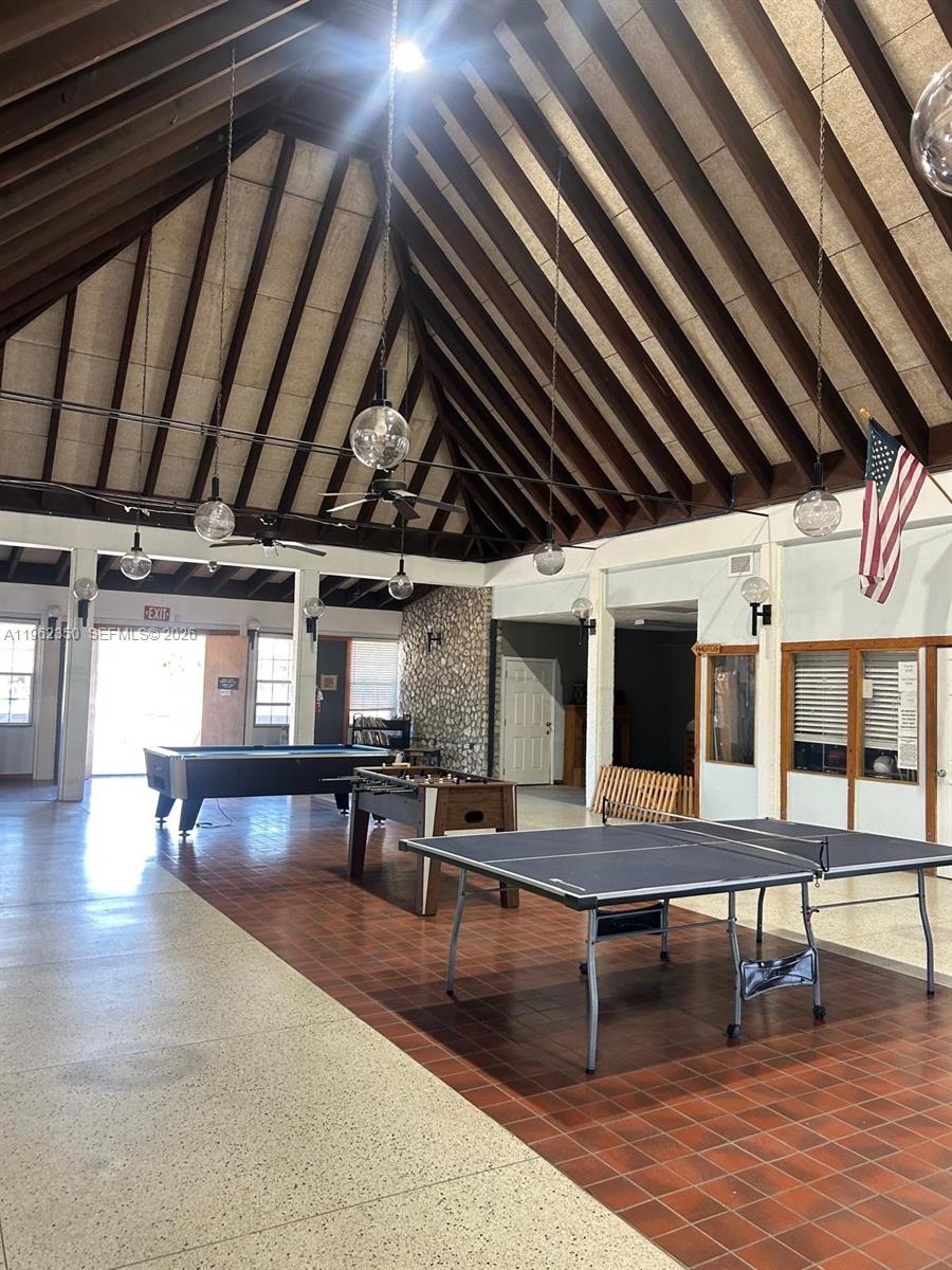 648 Hunting Club Avenue Clewiston, FL 33440 - Photo 20 of 22 a view of a big room with furniture wooden floor and a ceiling fan