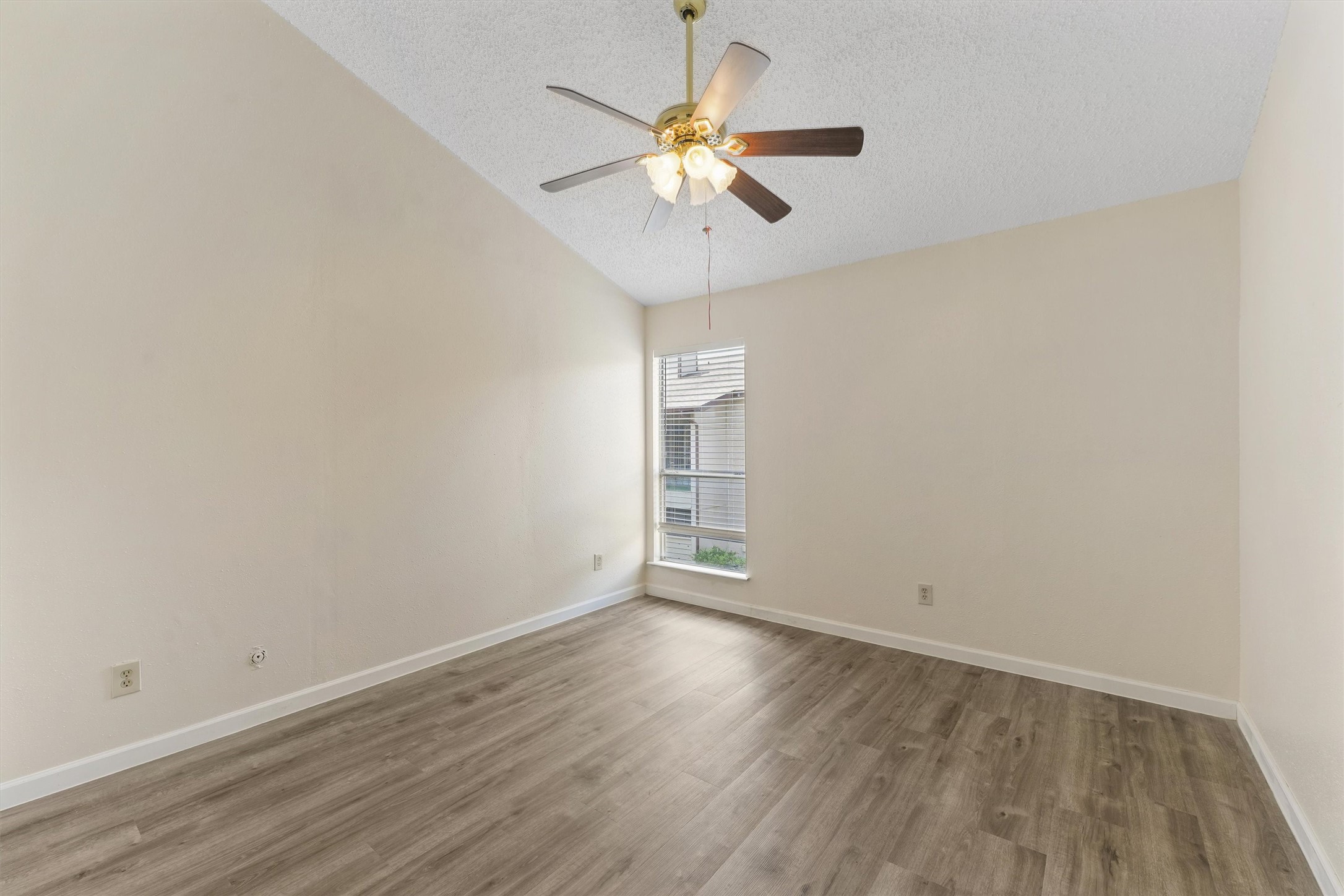 9221 Imogene Street, Unit 9221 Houston, TX 77036 - Photo 17 of 19 a view of an empty room with wooden floor