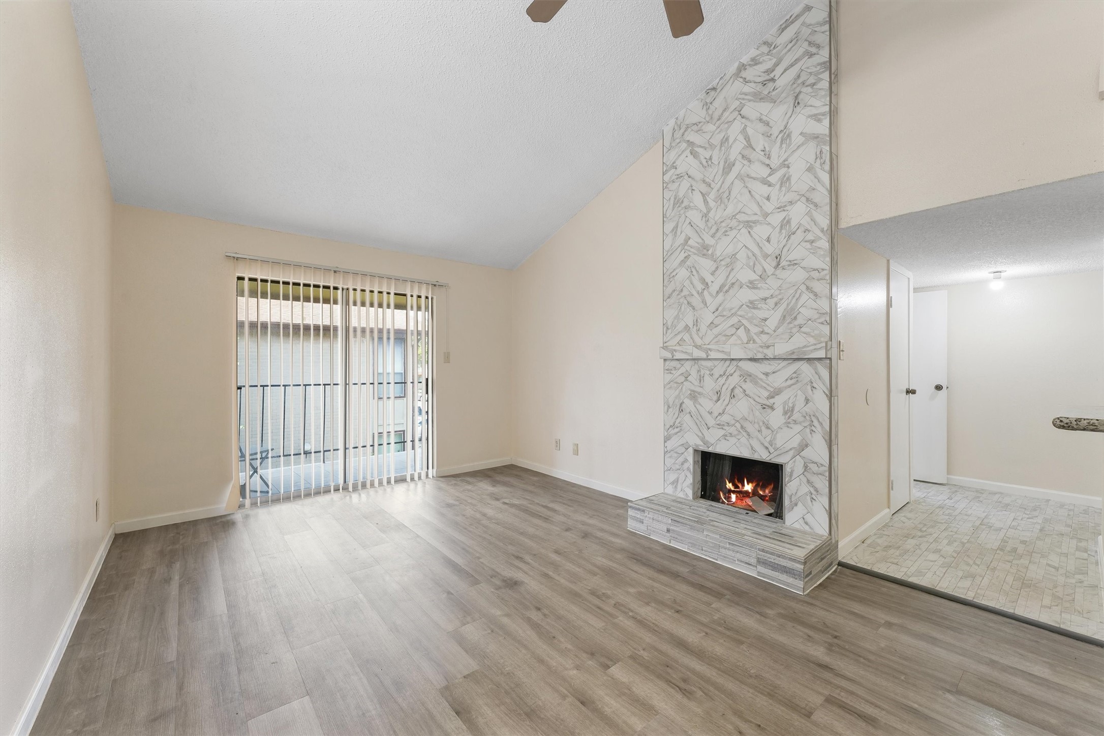 9221 Imogene Street, Unit 9221 Houston, TX 77036 - Photo 9 of 19 wooden floor in an empty room with a fireplace