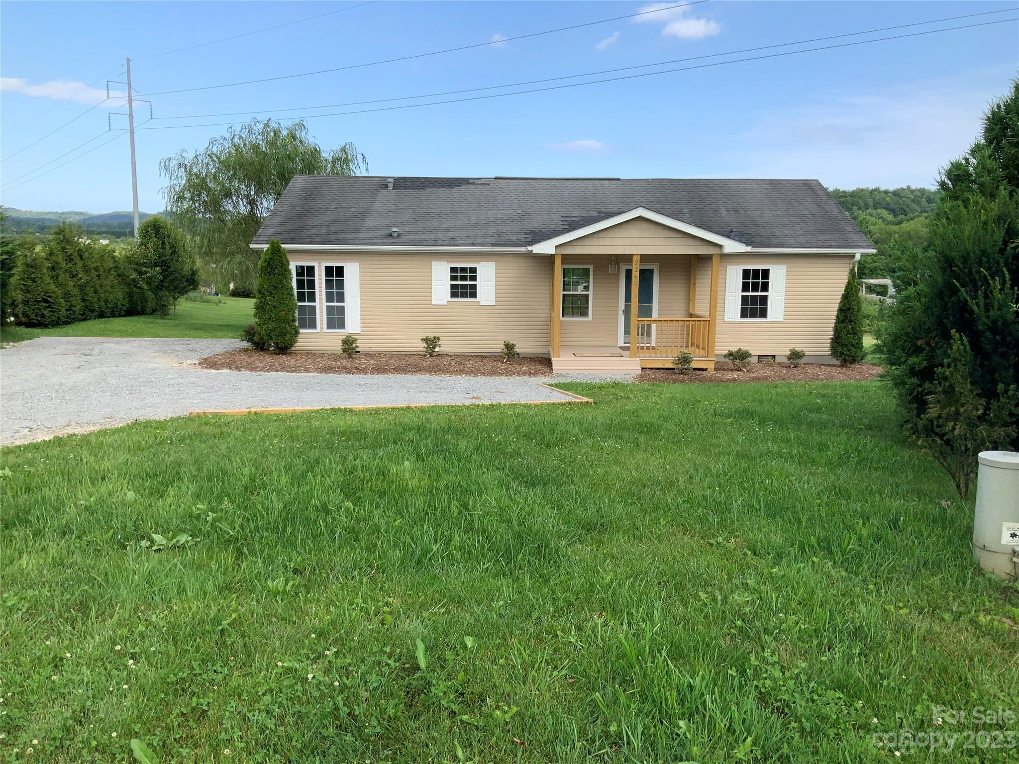 2240 Pace Road Hendersonville, NC 28792 - Photo 1 of 23 a front view of house with yard and trees in the background