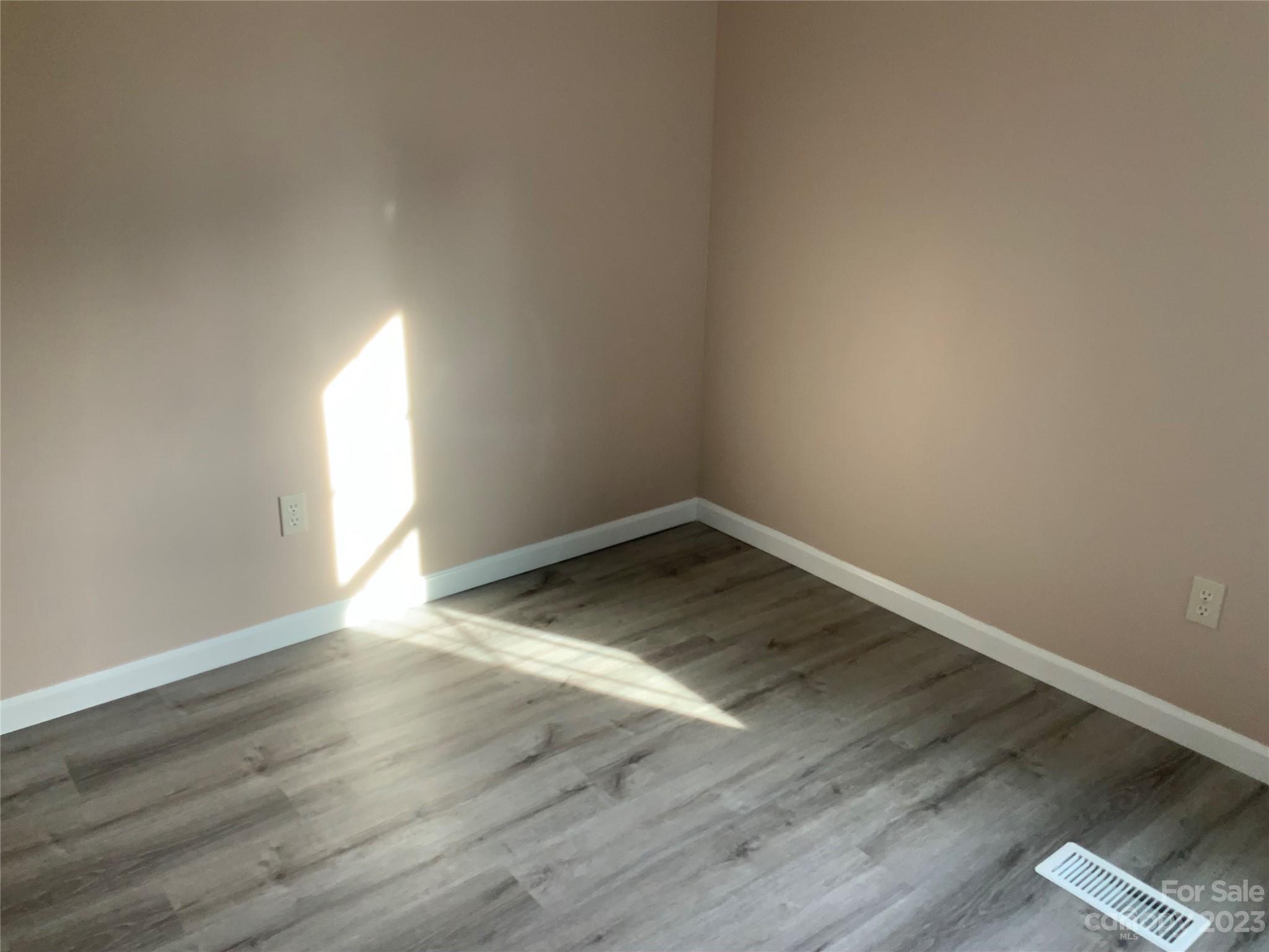 2240 Pace Road Hendersonville, NC 28792 - Photo 12 of 23 an empty room with wooden floor and windows