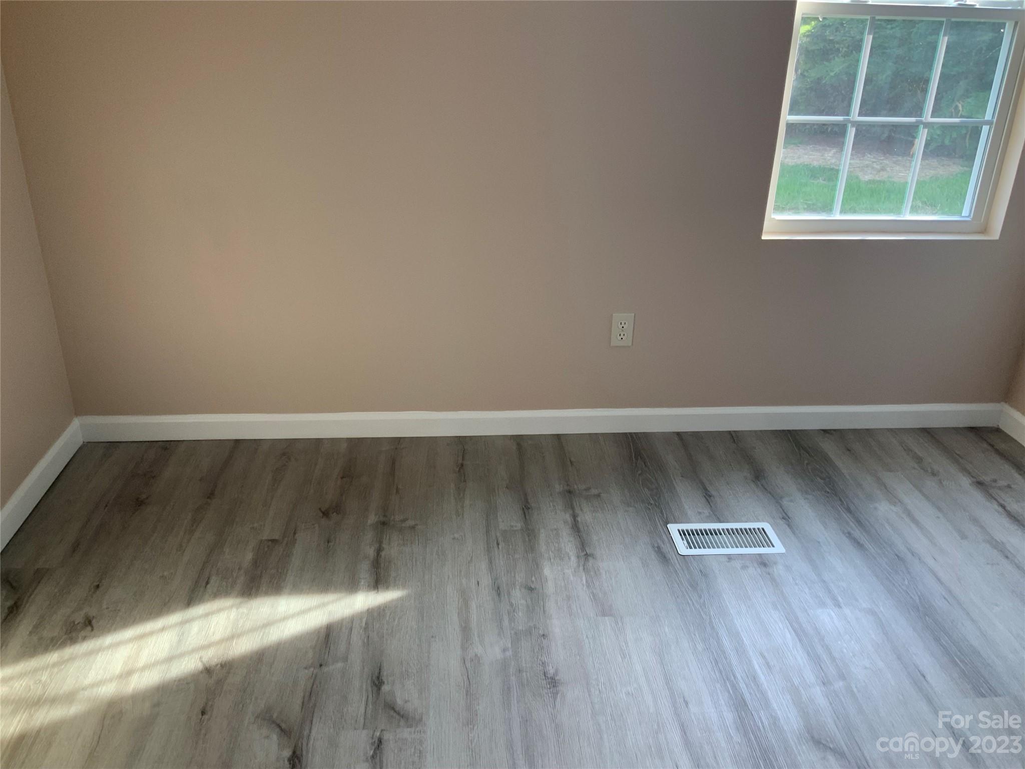 2240 Pace Road Hendersonville, NC 28792 - Photo 15 of 23 an empty room with wooden floor and windows