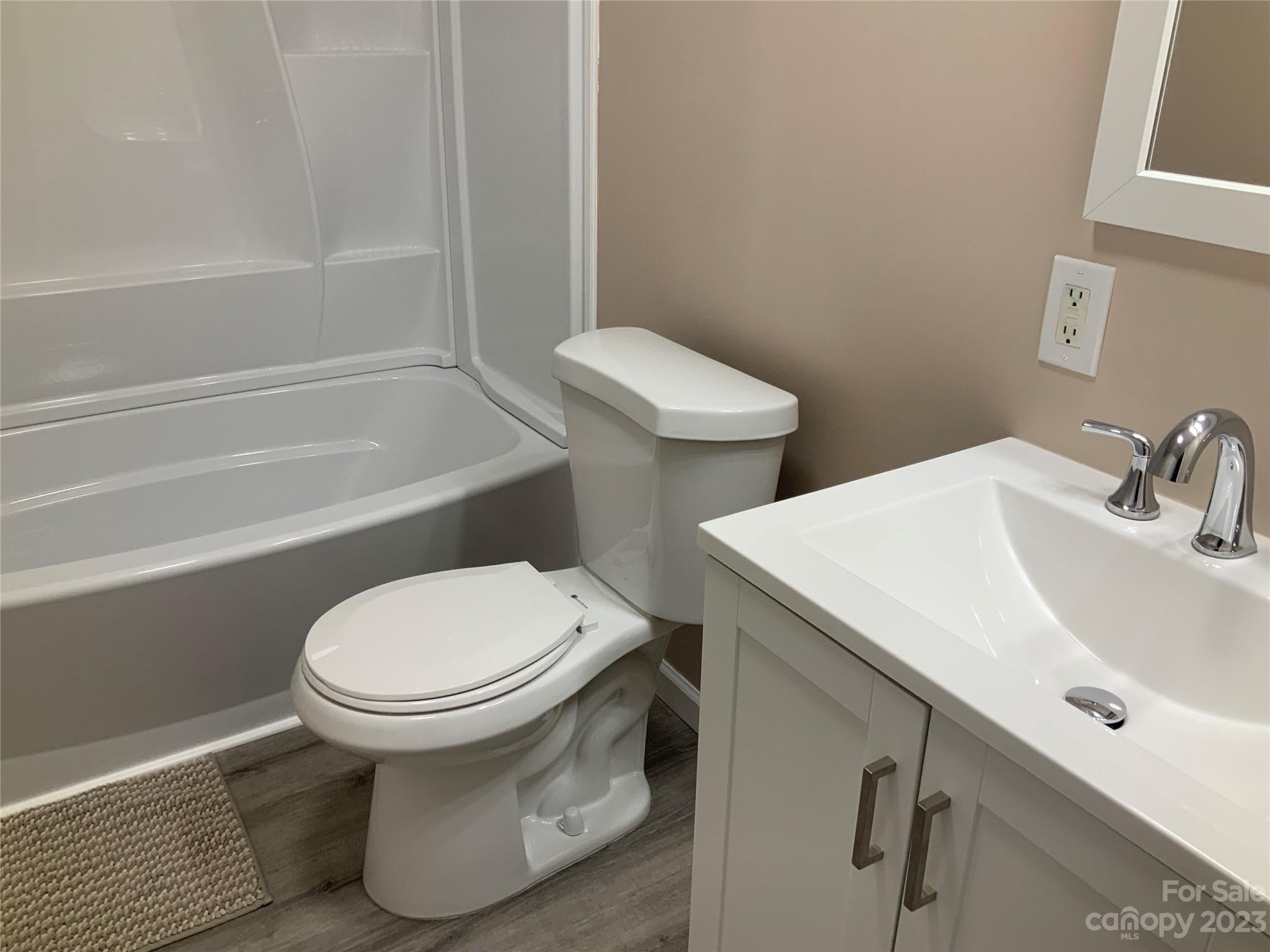 2240 Pace Road Hendersonville, NC 28792 - Photo 17 of 23 a white toilet sitting next to a bath tub