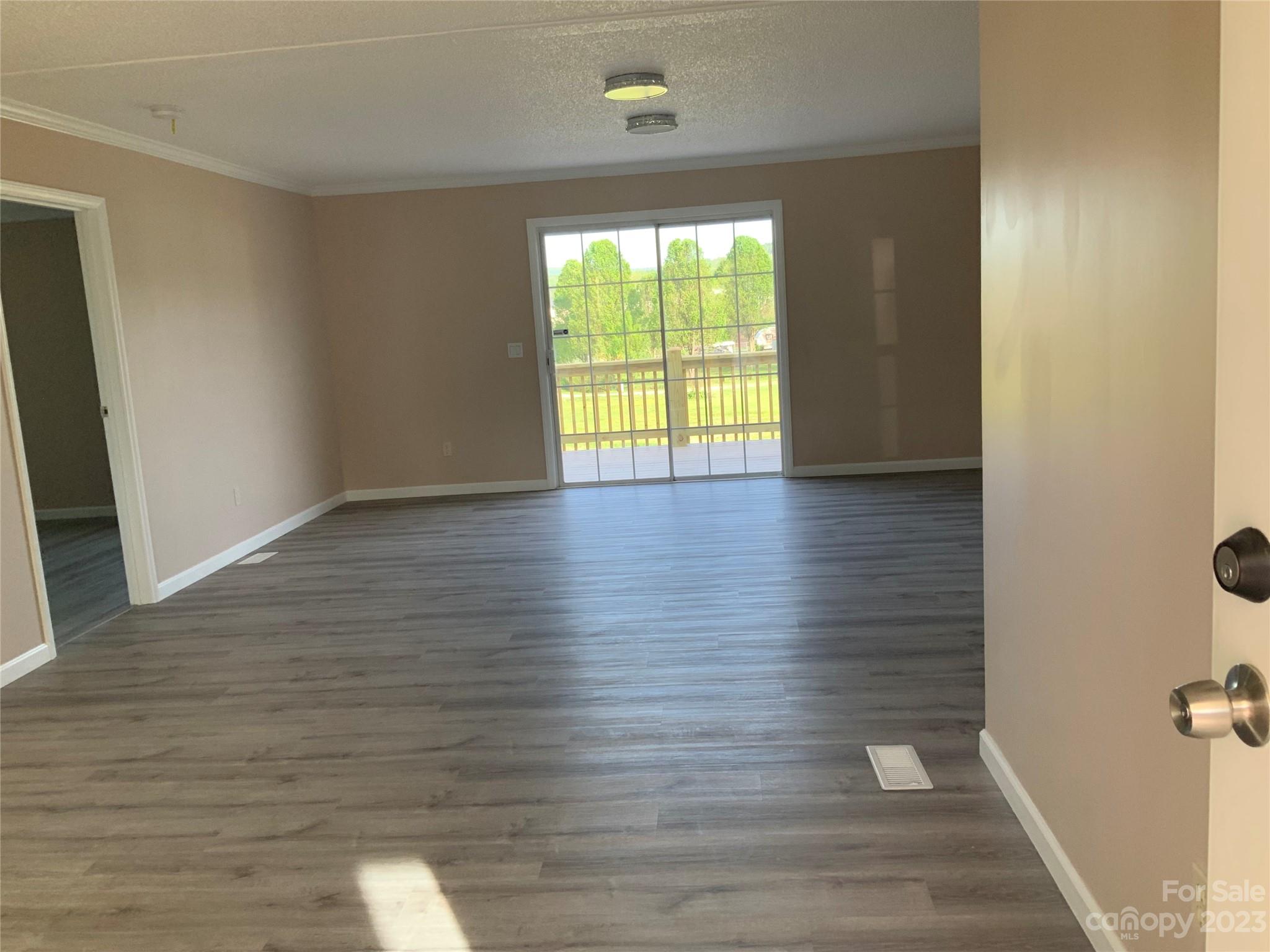 2240 Pace Road Hendersonville, NC 28792 - Photo 5 of 23 a view of an empty room with wooden floor and a window