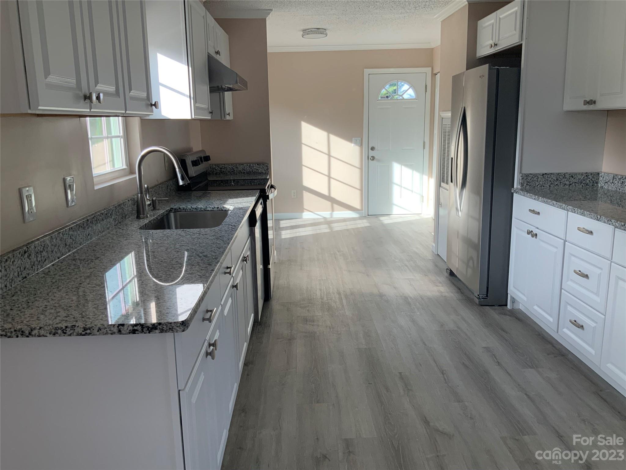 2240 Pace Road Hendersonville, NC 28792 - Photo 6 of 23 a kitchen with granite countertop a sink and a refrigerator
