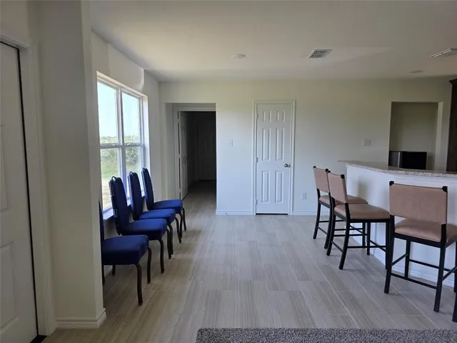 a view of a livingroom with furniture a couch and wooden floor
