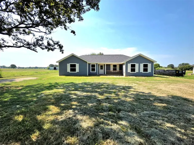 a house view with swimming pool in front of it