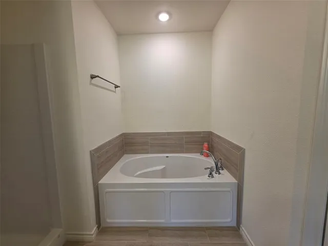 a bathroom with a bathtub and shower