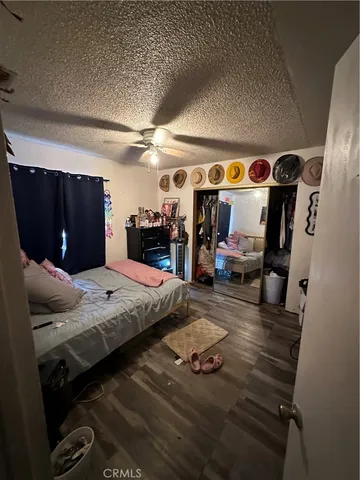 a bedroom with furniture and a mirror