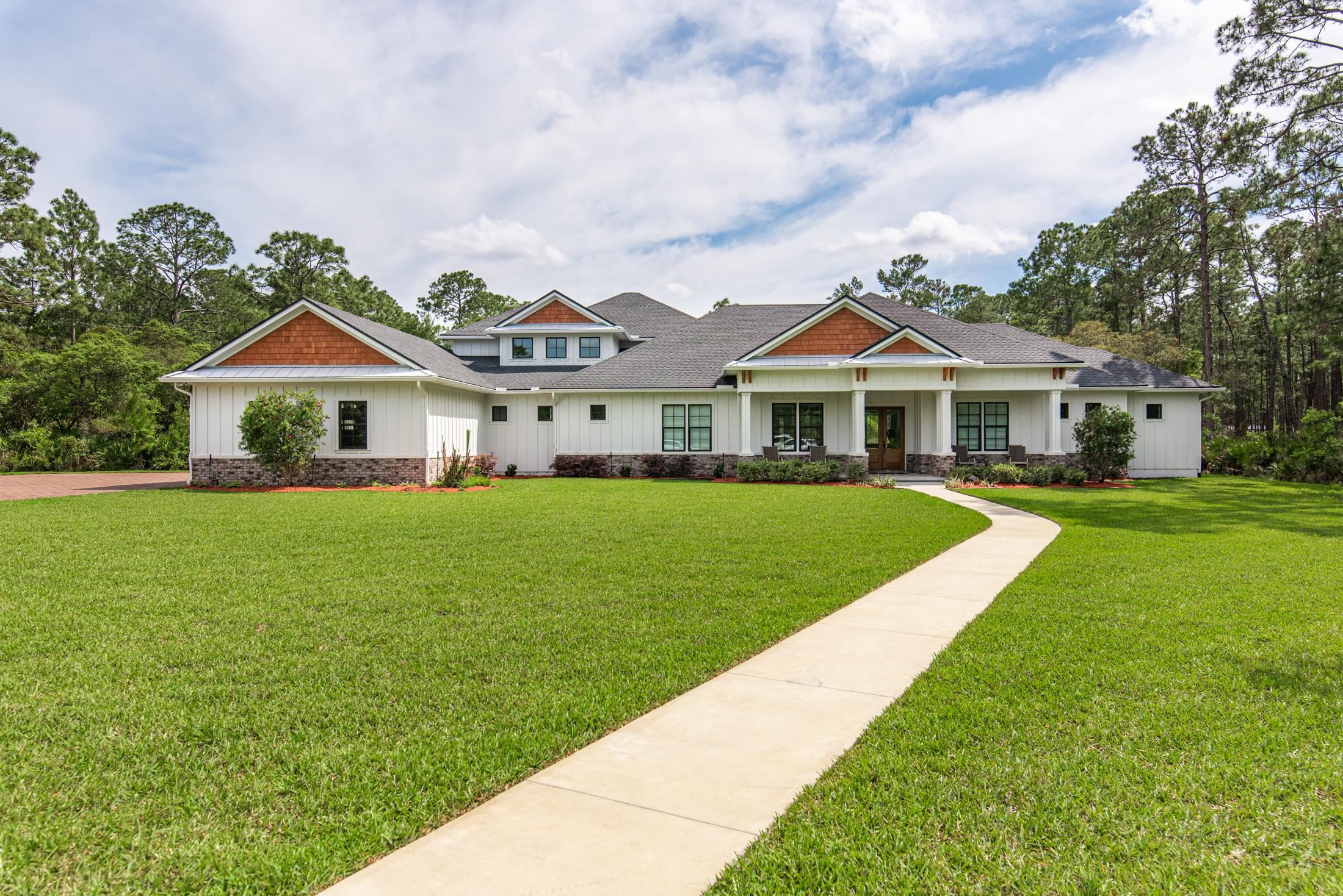 1015 Poinsettia Road St. Augustine, FL 32086 - Photo 1 of 50 a front view of a house with a yard