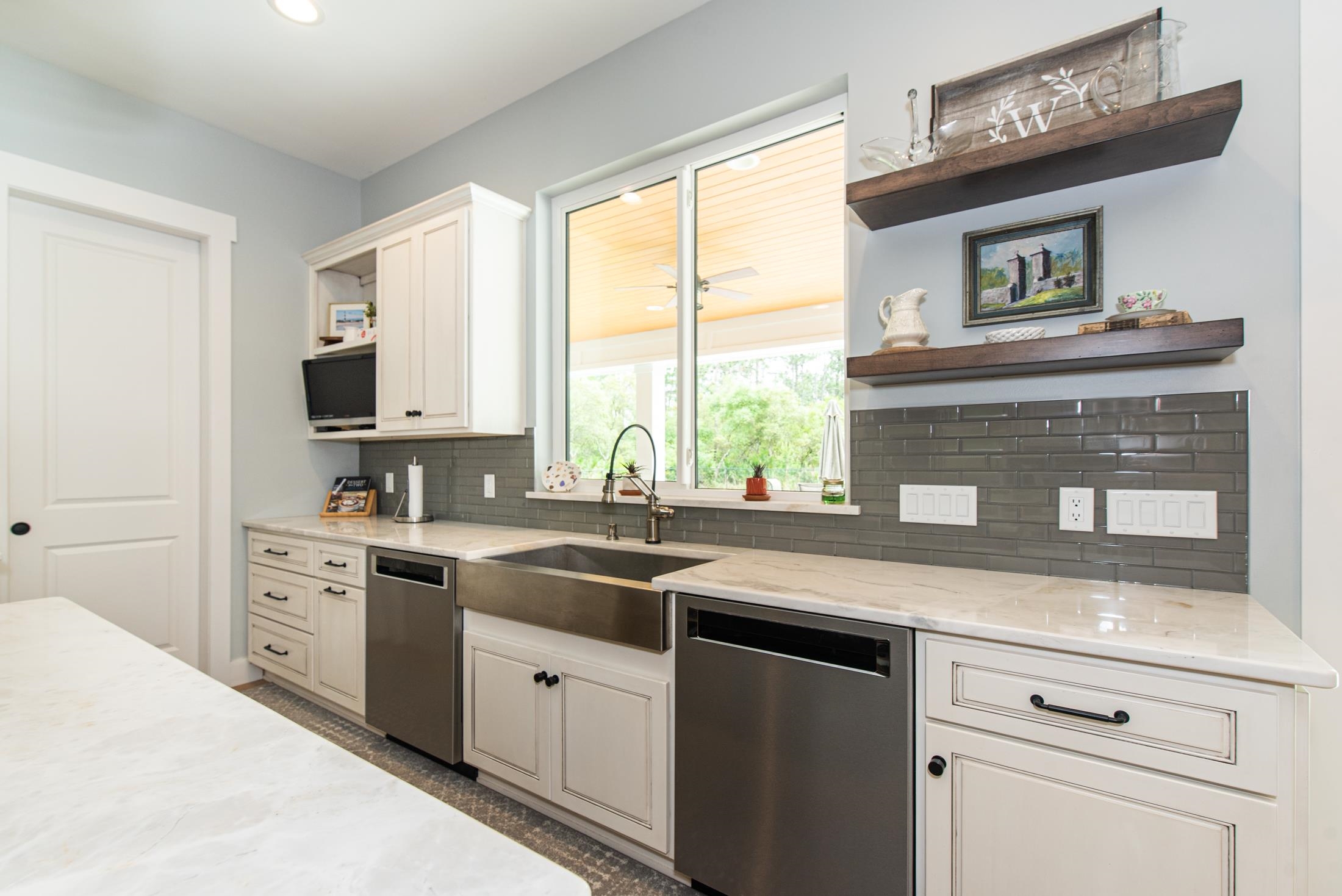 1015 Poinsettia Road St. Augustine, FL 32086 - Photo 13 of 50 a kitchen with stainless steel appliances granite countertop a sink a stove and cabinets