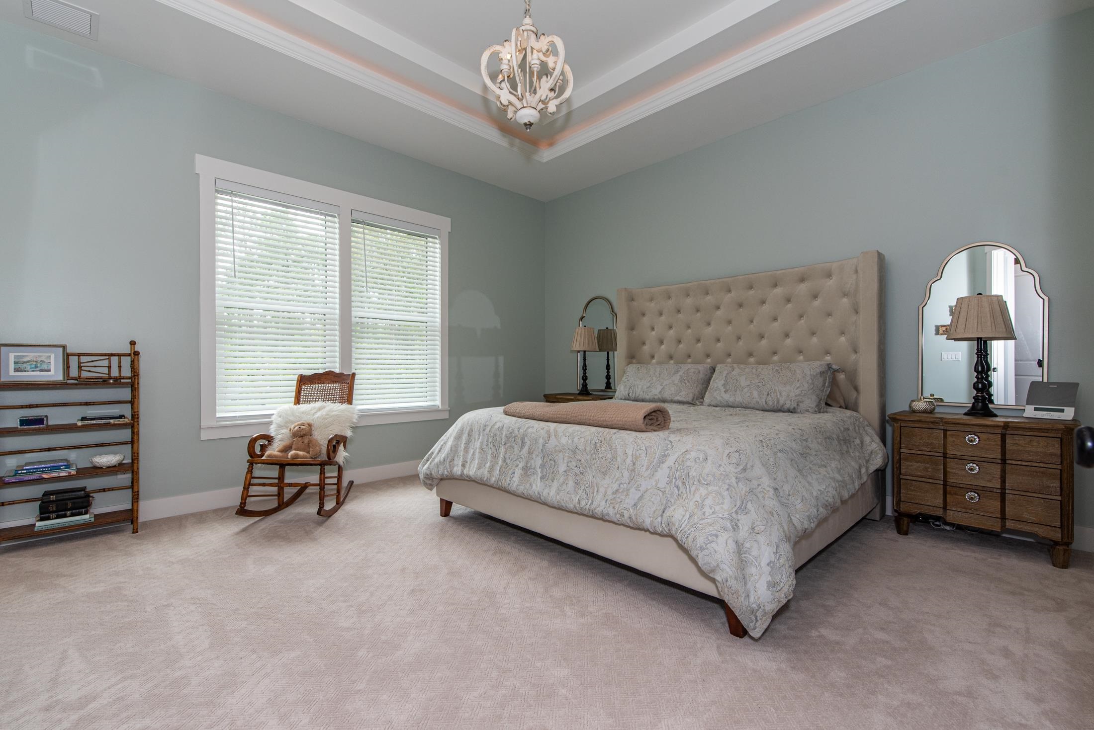 1015 Poinsettia Road St. Augustine, FL 32086 - Photo 17 of 50 a bedroom with a bed and a chandelier