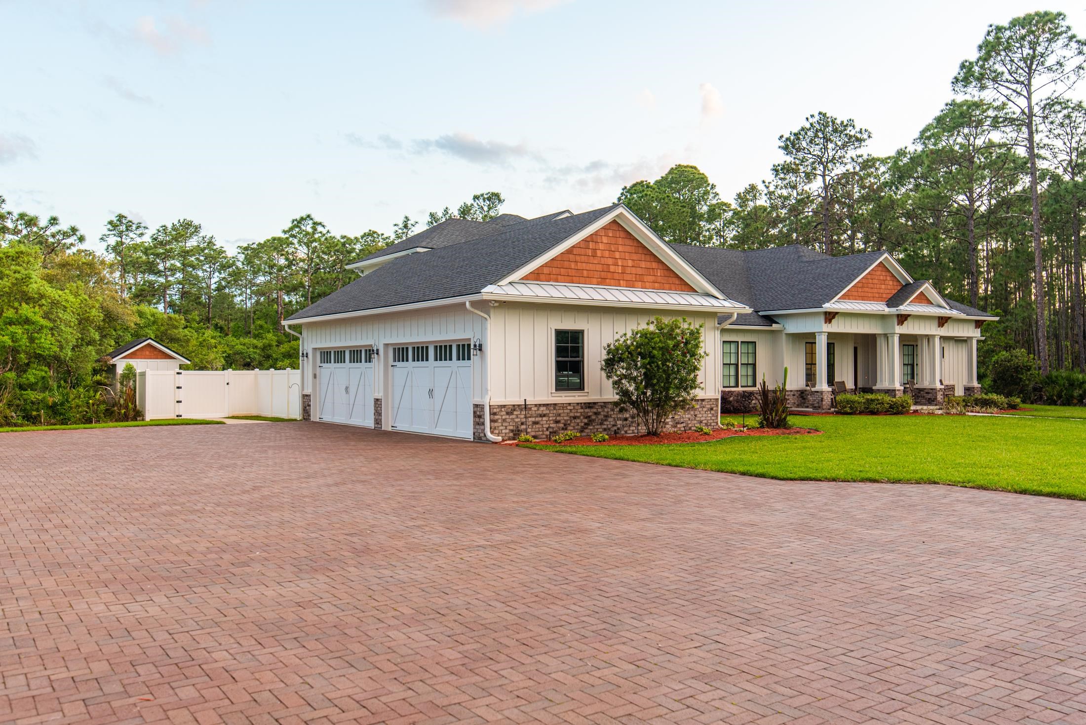 1015 Poinsettia Road St. Augustine, FL 32086 - Photo 34 of 50 a front view of a house with a yard and garage