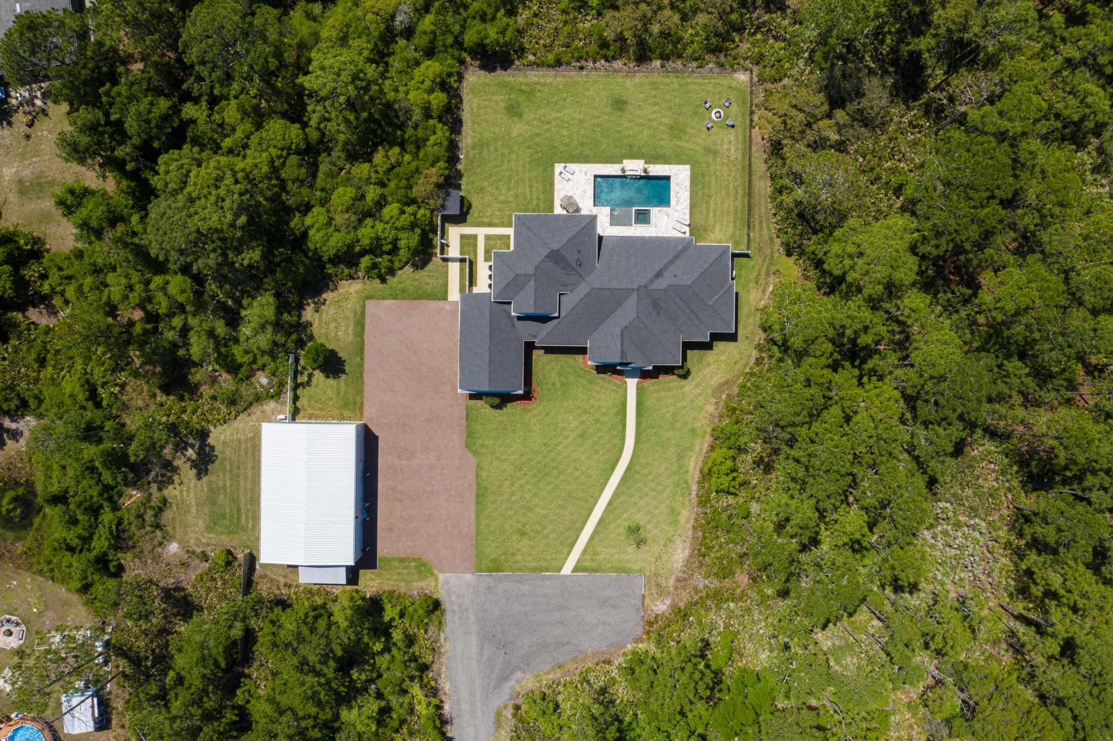 1015 Poinsettia Road St. Augustine, FL 32086 - Photo 37 of 50 an aerial view of a house with a garden