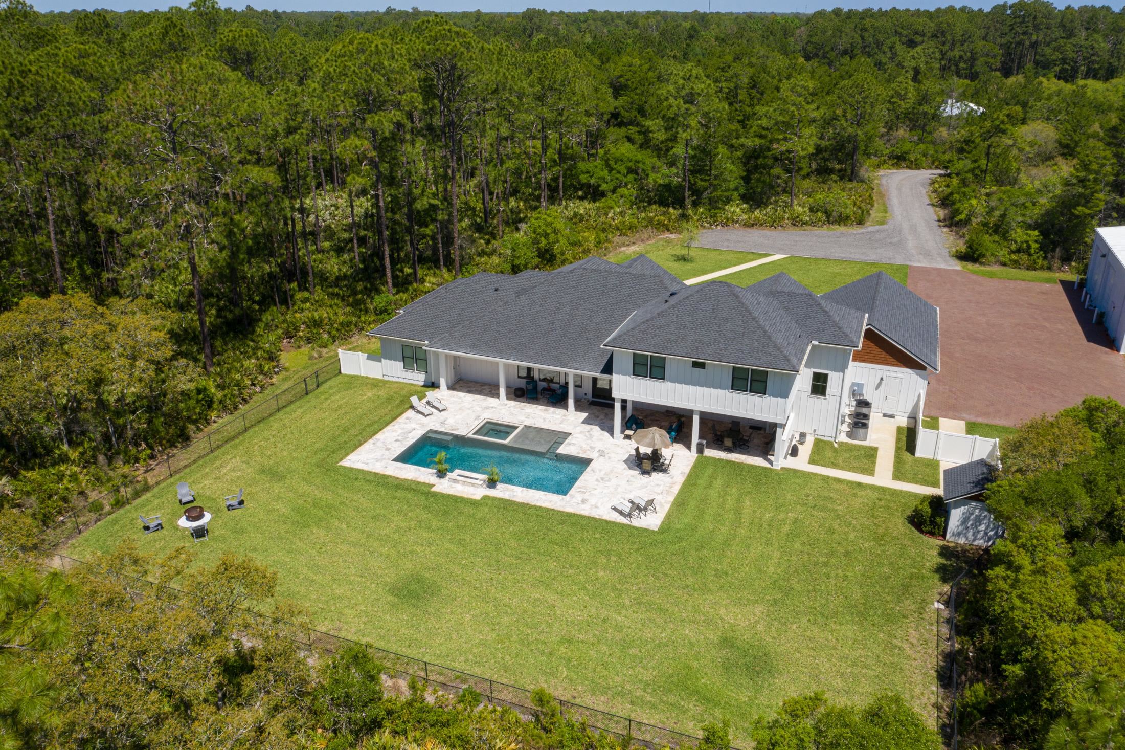 1015 Poinsettia Road St. Augustine, FL 32086 - Photo 38 of 50 an aerial view of a house with swimming pool big yard and large trees