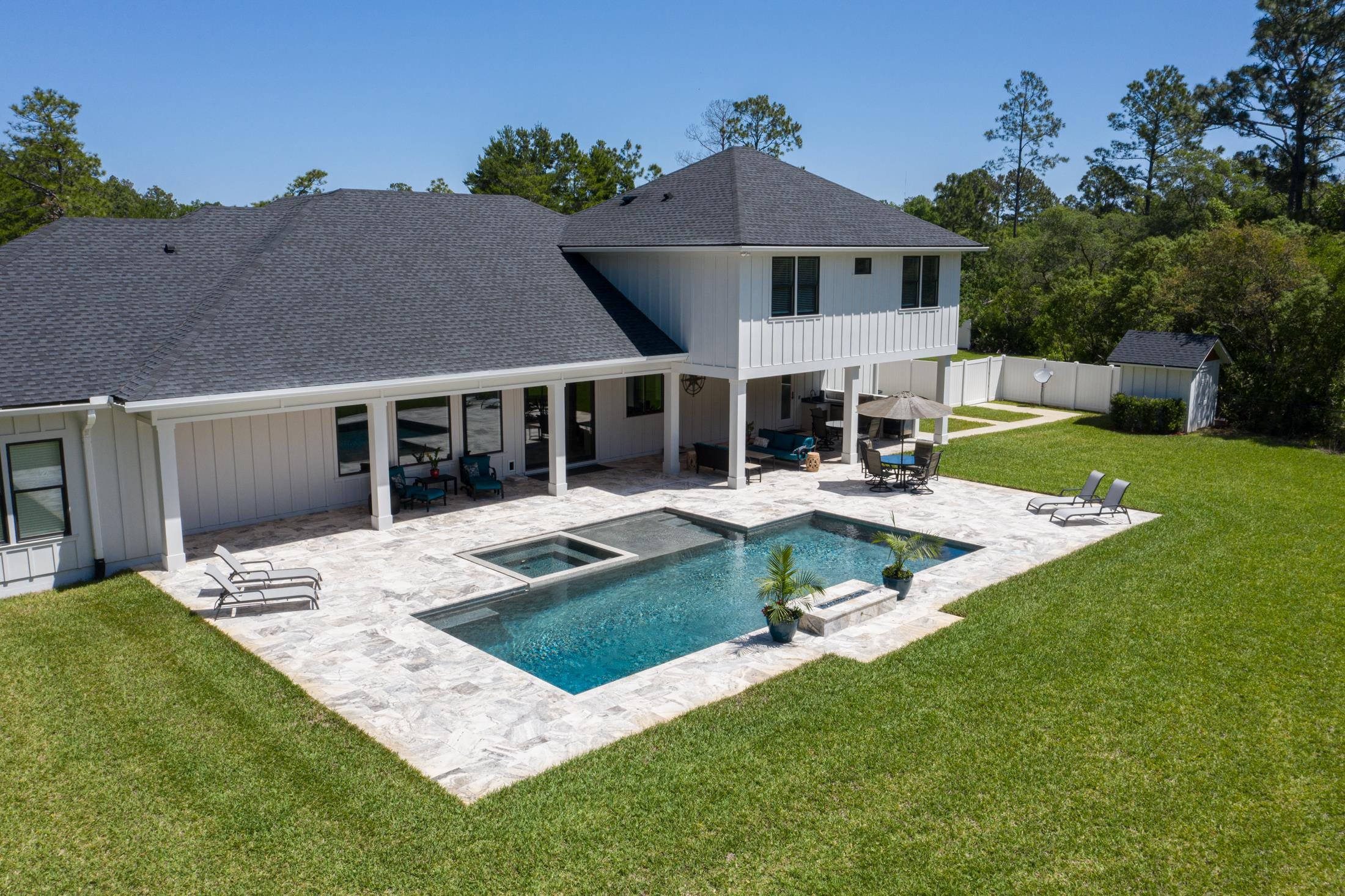 1015 Poinsettia Road St. Augustine, FL 32086 - Photo 39 of 50 a front view of a house with garden and porch